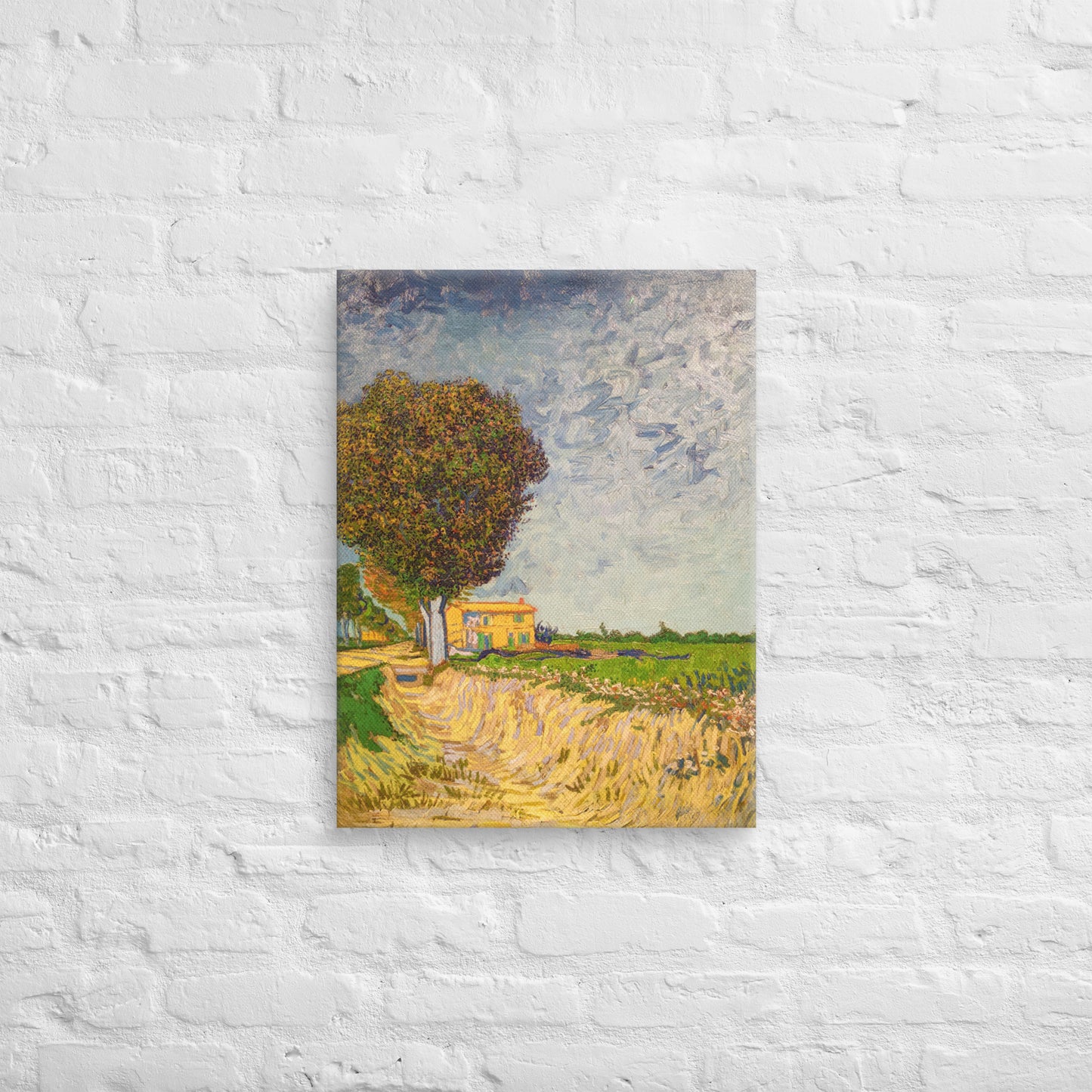 Van Gogh's 'A Lane near Arles' on a 18"x24" unframed canvas print on a white brick wall.