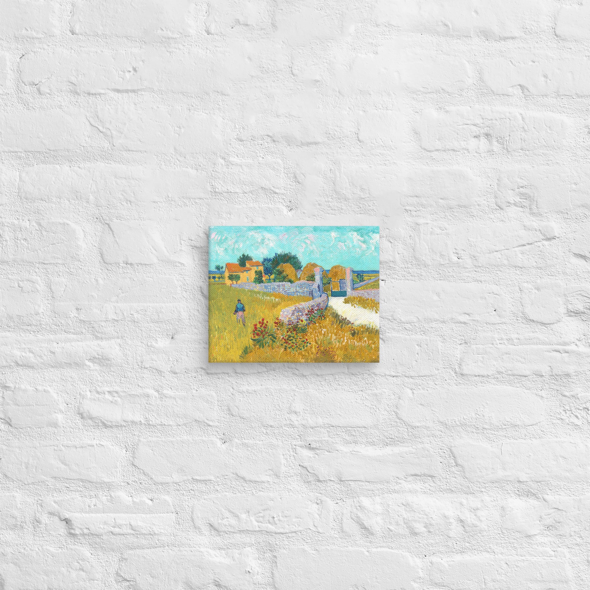 Van Gogh's 'Farmhouse in Provence' on a 8"x10" unframed canvas print on a white brick wall.