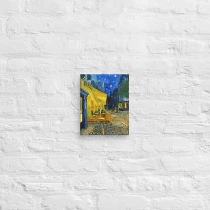 Van Gogh's 'Café Terrace at Night' on a 8"x10" unframed canvas print on a white brick wall.