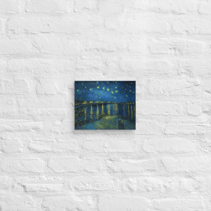 Van Gogh's 'Starry Night Over the Rhone' on a 8"x10" unframed canvas print on a white brick wall.