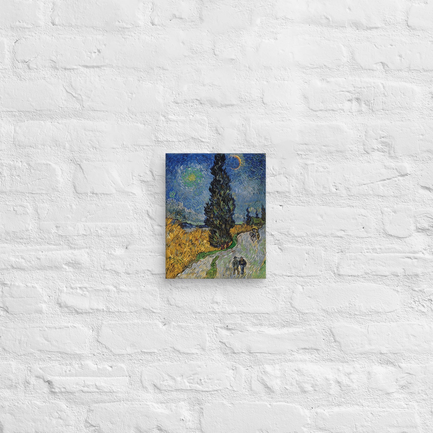 Van Gogh's 'Road with Cypress and Star' on a 8"x10" unframed canvas print on a white brick wall.
