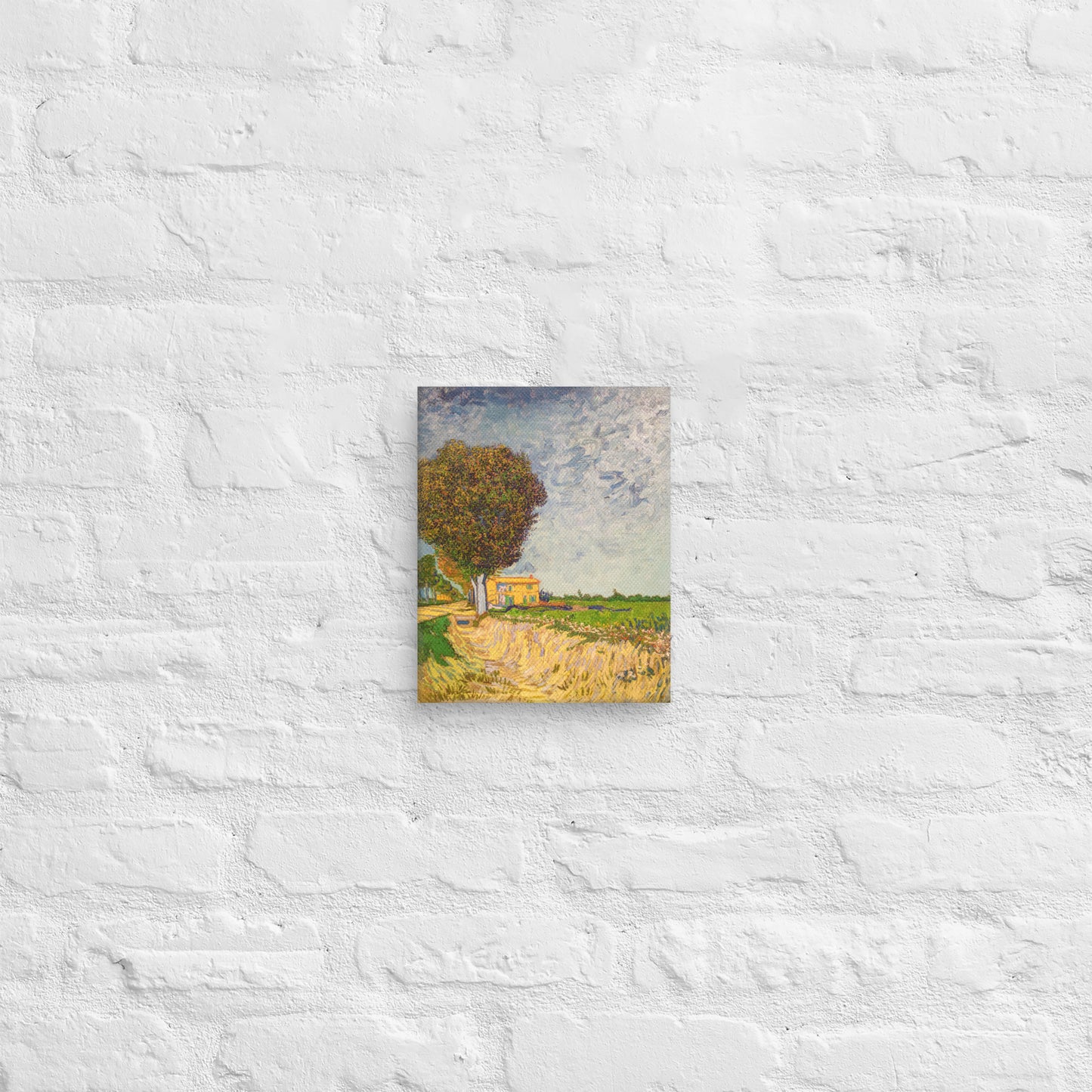 Van Gogh's 'A Lane near Arles' on a 8"x10" unframed canvas print on a white brick wall.