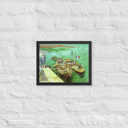 Van Gogh's 'Quay with Men Unloading Sand Barges' on a 11"x14" black framed poster print on a white brick wall.