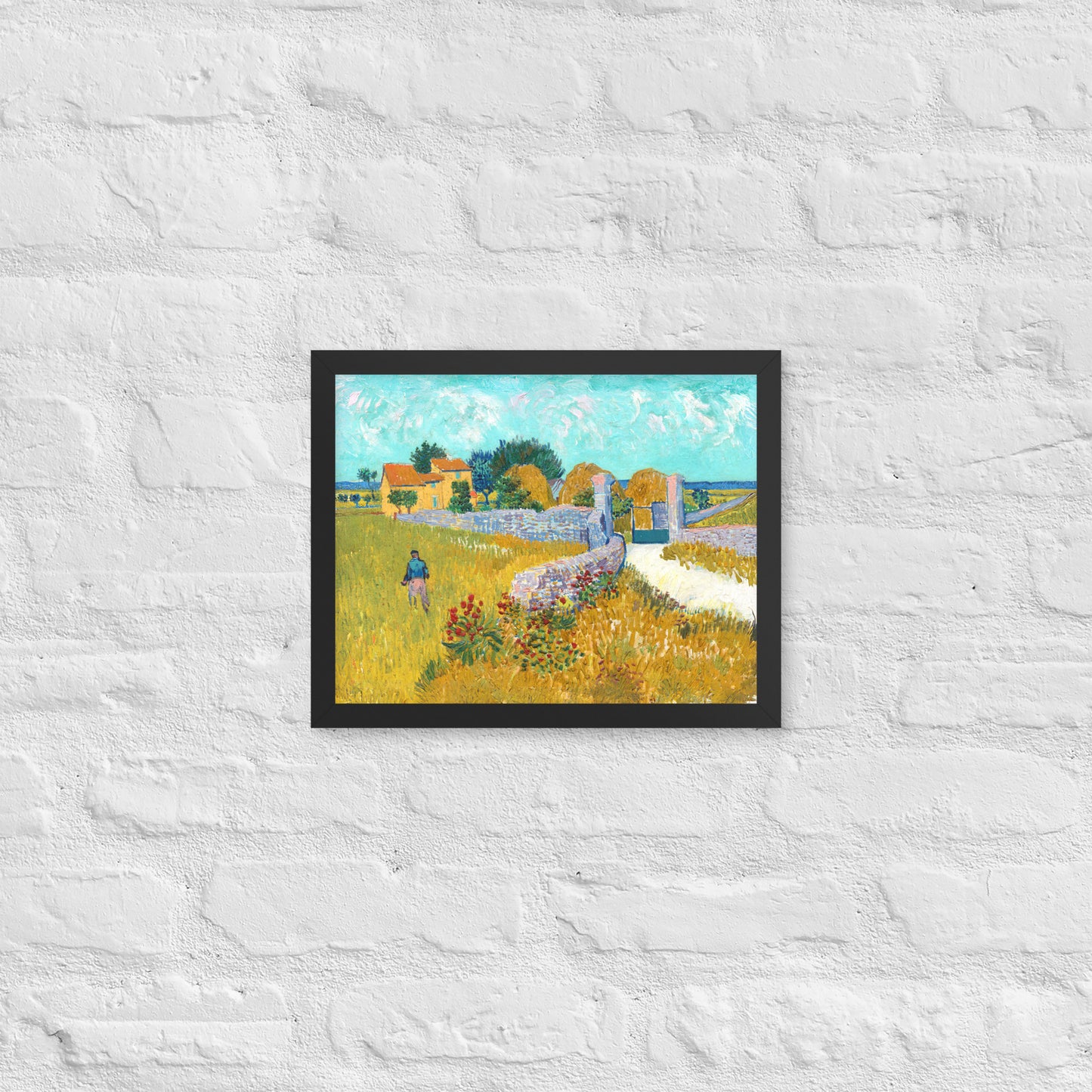 Van Gogh's 'Farmhouse in Provence' on a 11"x14" black framed poster print on a white brick wall.