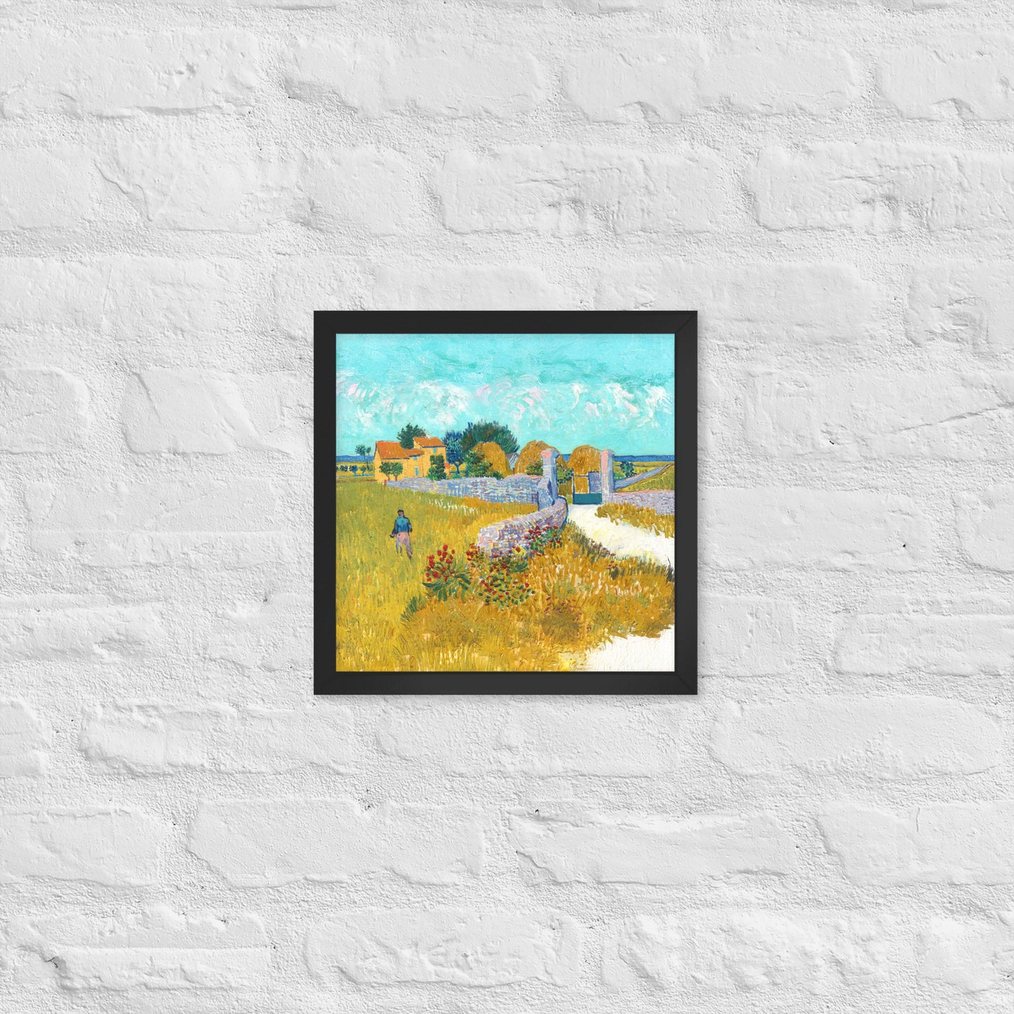 Van Gogh's 'Farmhouse in Provence' on a 12"x12" black framed poster print on a white brick wall.