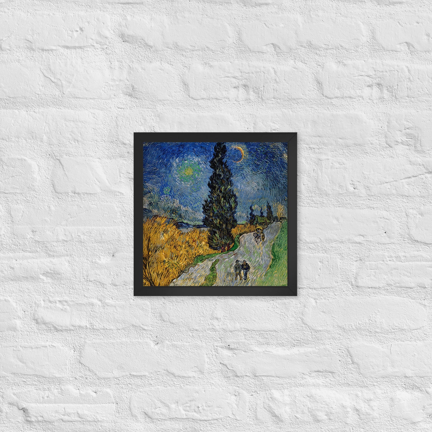 Van Gogh's 'Road with Cypress and Star' on a 12"x12" black framed poster print on a white brick wall.
