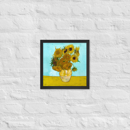 Van Gogh's 'Vase with Twelve Sunflowers' on a 12"x12" black framed poster print on a white brick wall.
