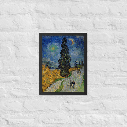 Van Gogh's 'Road with Cypress and Star' on a 12"x16" black framed poster print on a white brick wall.