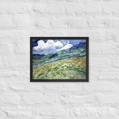 Van Gogh's 'Landscape from Saint-Rémy' on a 12"x16" black framed poster print on a white brick wall.
