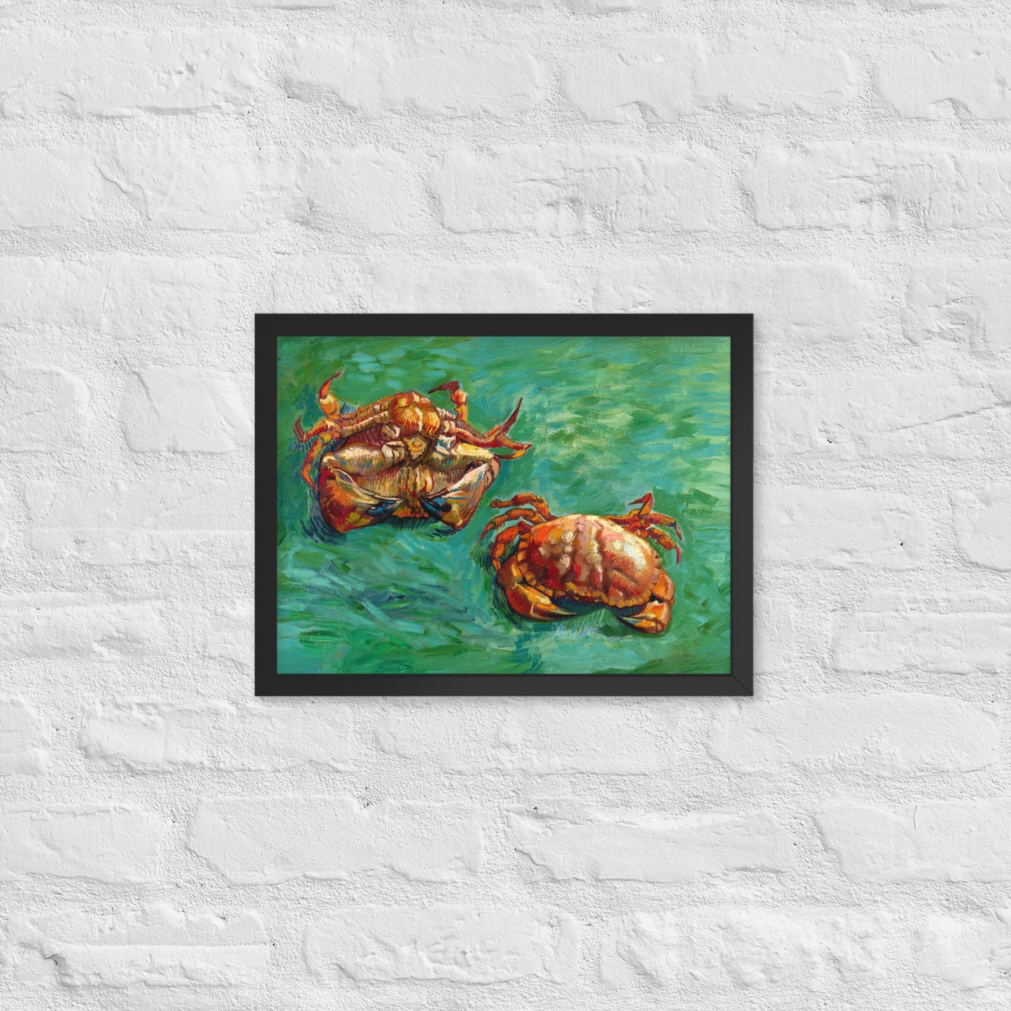Van Gogh's 'Two Crabs' on a 12"x16" black framed poster print on a white brick wall.