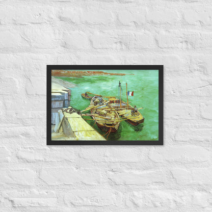 Van Gogh's 'Quay with Men Unloading Sand Barges' on a 12"x18" black framed poster print on a white brick wall.
