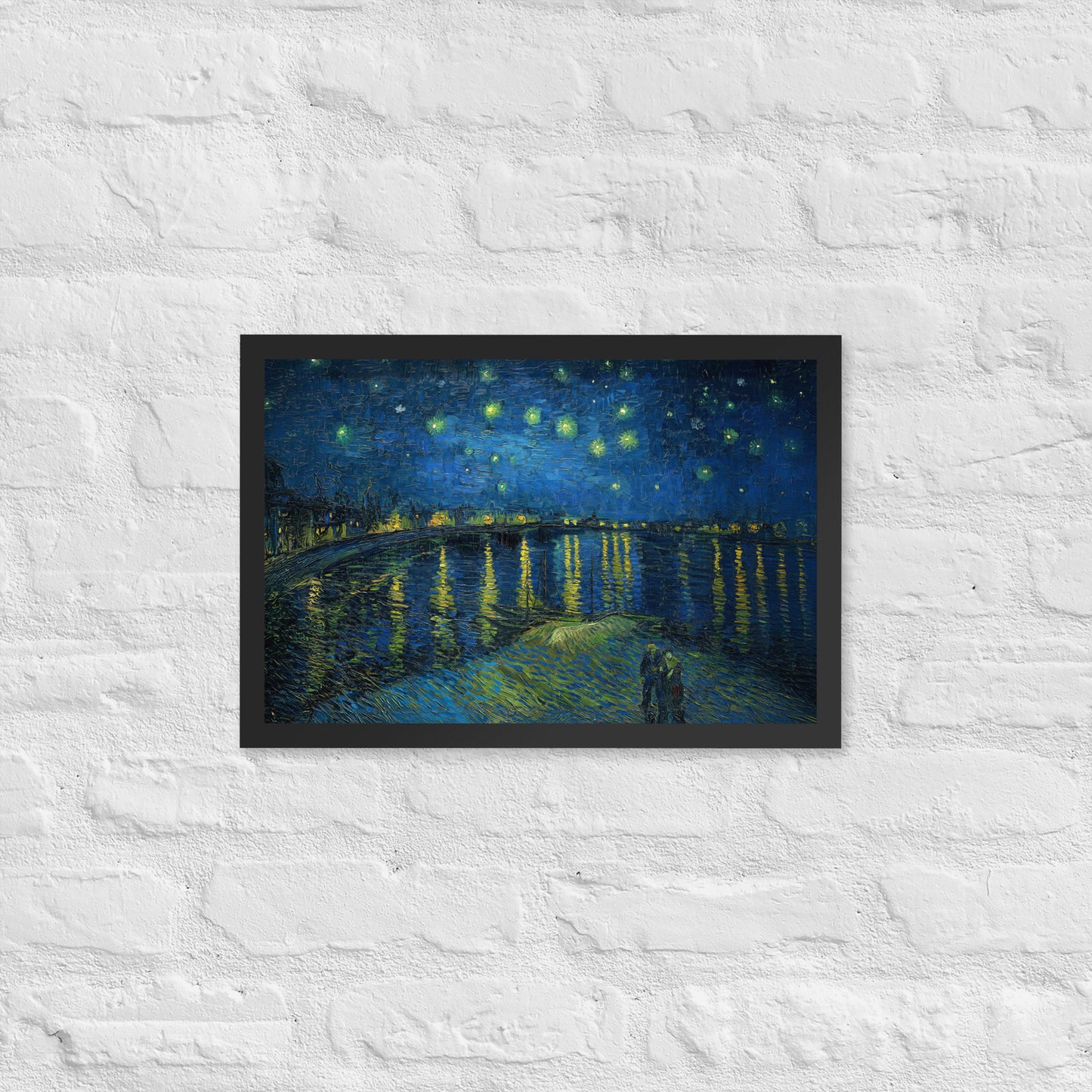 Van Gogh's 'Starry Night Over the Rhone' on a 12"x18" black framed poster print on a white brick wall.