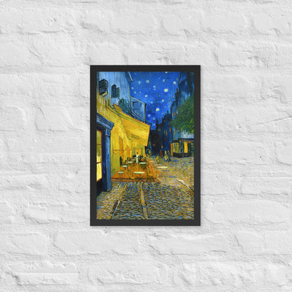 Van Gogh's 'Café Terrace at Night' on a 12"x18" black framed poster print on a white brick wall.