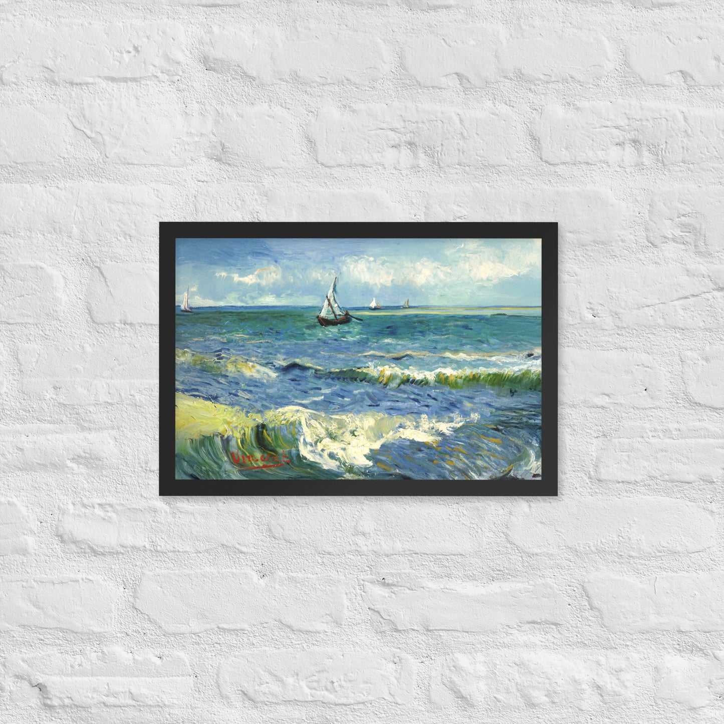 Van Gogh's 'The Sea at Les Saintes-Maries-de-la-Mer' on a 12"x18" black framed poster print on a white brick wall.