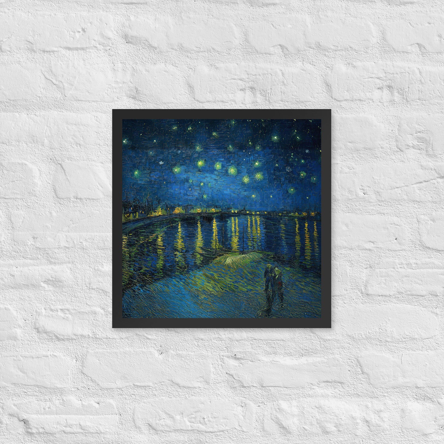 Van Gogh's 'Starry Night Over the Rhone' on a 16"x16" black framed poster print on a white brick wall.