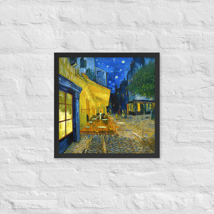 Van Gogh's 'Café Terrace at Night' on a 16"x16" black framed poster print on a white brick wall.