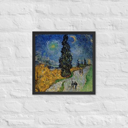 Van Gogh's 'Road with Cypress and Star' on a 16"x16" black framed poster print on a white brick wall.