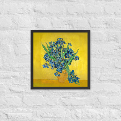 Van Gogh's 'Vase with Irises Against a Yellow Background' on a 16"x16" black framed poster print on a white brick wall.