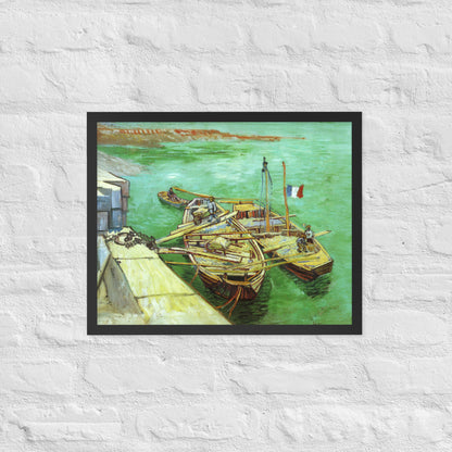 Van Gogh's 'Quay with Men Unloading Sand Barges' on a 16"x20" black framed poster print on a white brick wall.