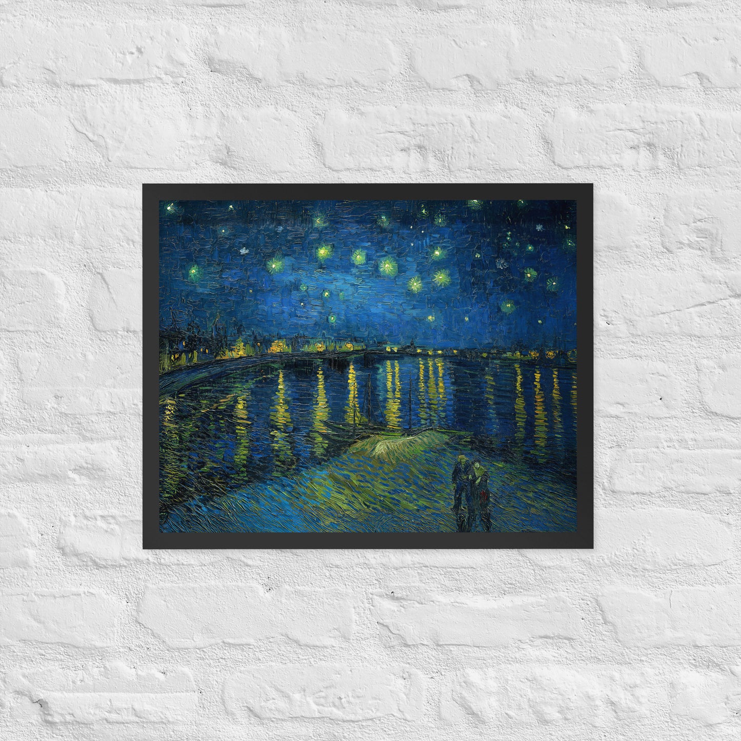 Van Gogh's 'Starry Night Over the Rhone' on a 16"x20" black framed poster print on a white brick wall.