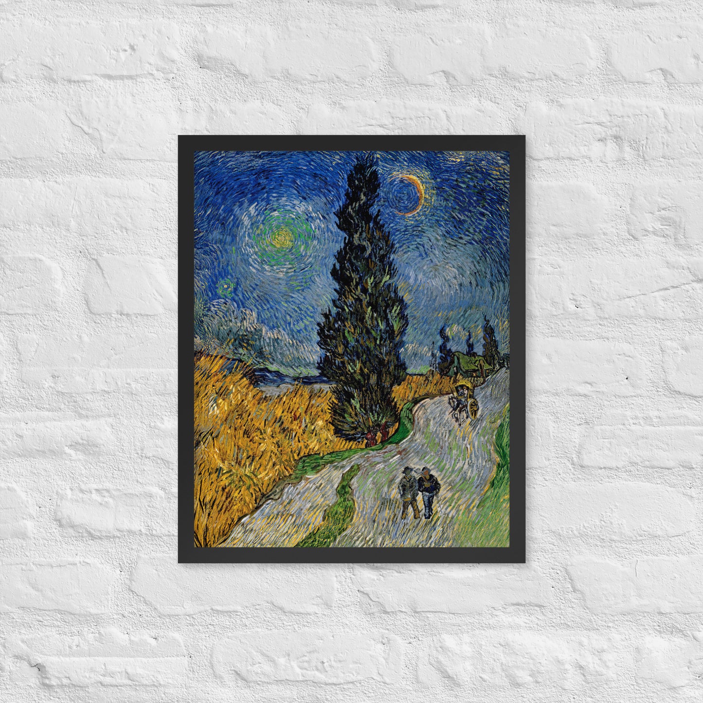 Van Gogh's 'Road with Cypress and Star' on a 16"x20" black framed poster print on a white brick wall.