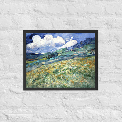 Van Gogh's 'Landscape from Saint-Rémy' on a 16"x20" black framed poster print on a white brick wall.