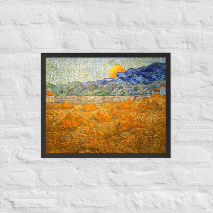 Van Gogh's 'Landscape with Wheat Sheaves and Rising Moon' on a 16"x20" black framed poster print on a white brick wall.