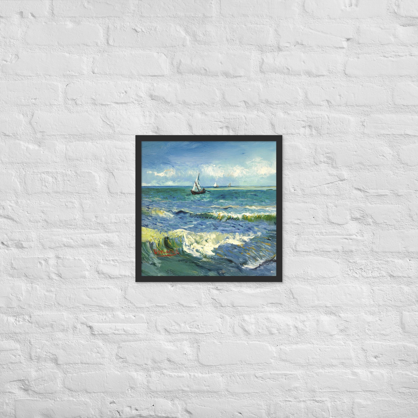 Van Gogh's 'The Sea at Les Saintes-Maries-de-la-Mer' on a 18"x18" black framed poster print on a white brick wall.
