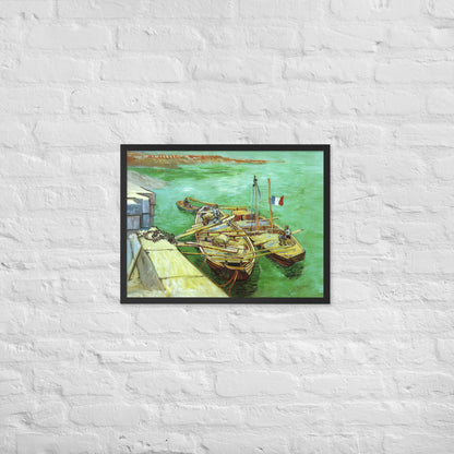 Van Gogh's 'Quay with Men Unloading Sand Barges' on a 18"x24" black framed poster print on a white brick wall.