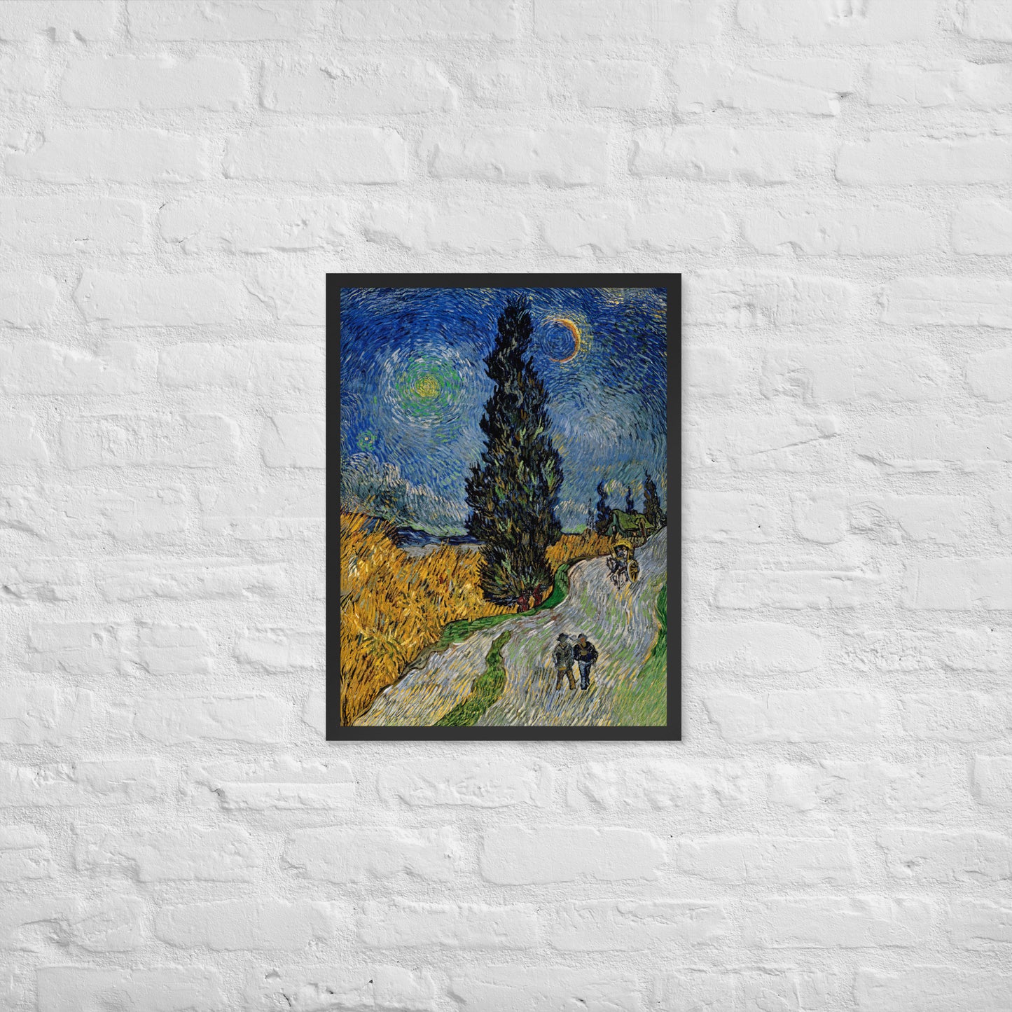 Van Gogh's 'Road with Cypress and Star' on a 18"x24" black framed poster print on a white brick wall.