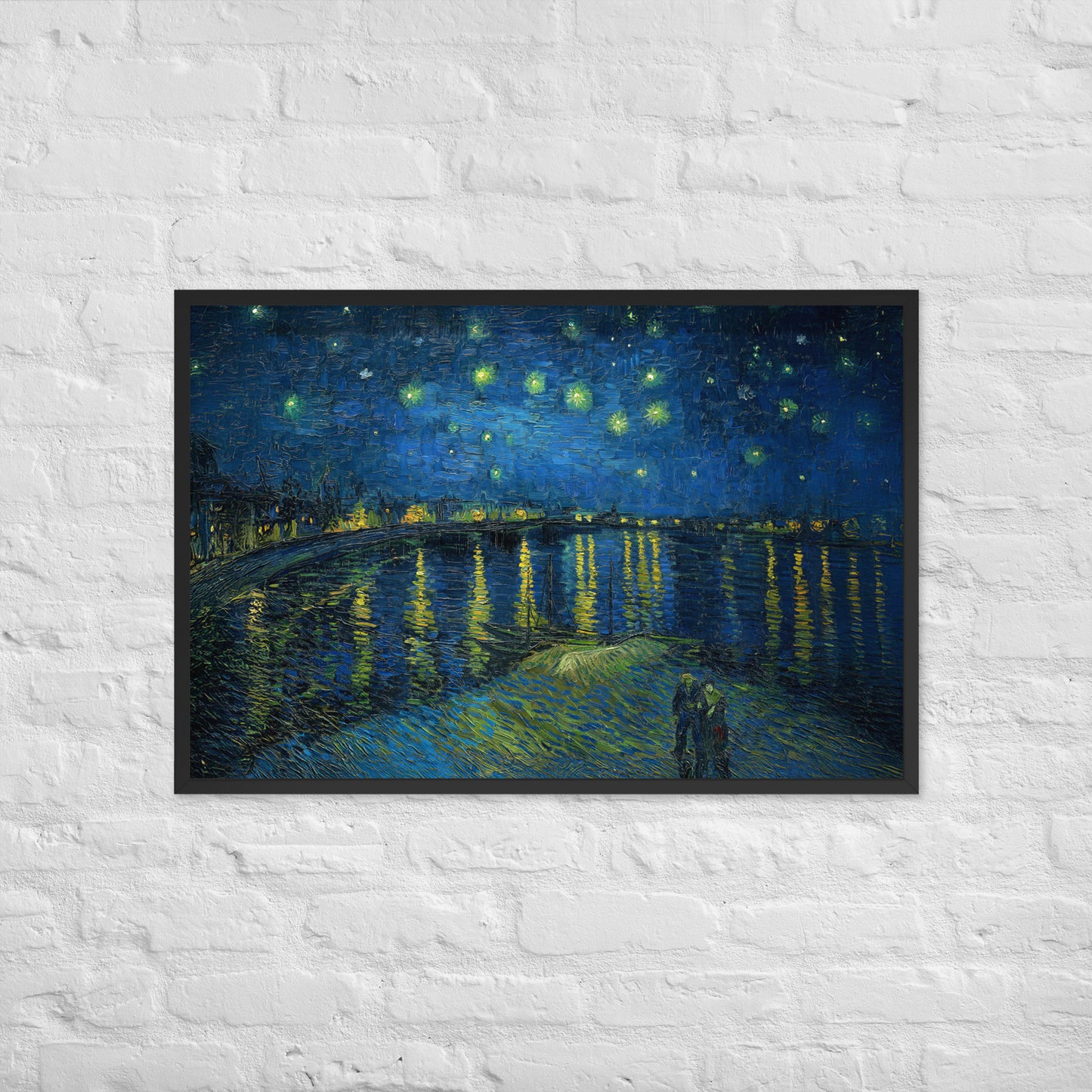 Van Gogh's 'Starry Night Over the Rhone' on a 24"x36" black framed poster print on a white brick wall.