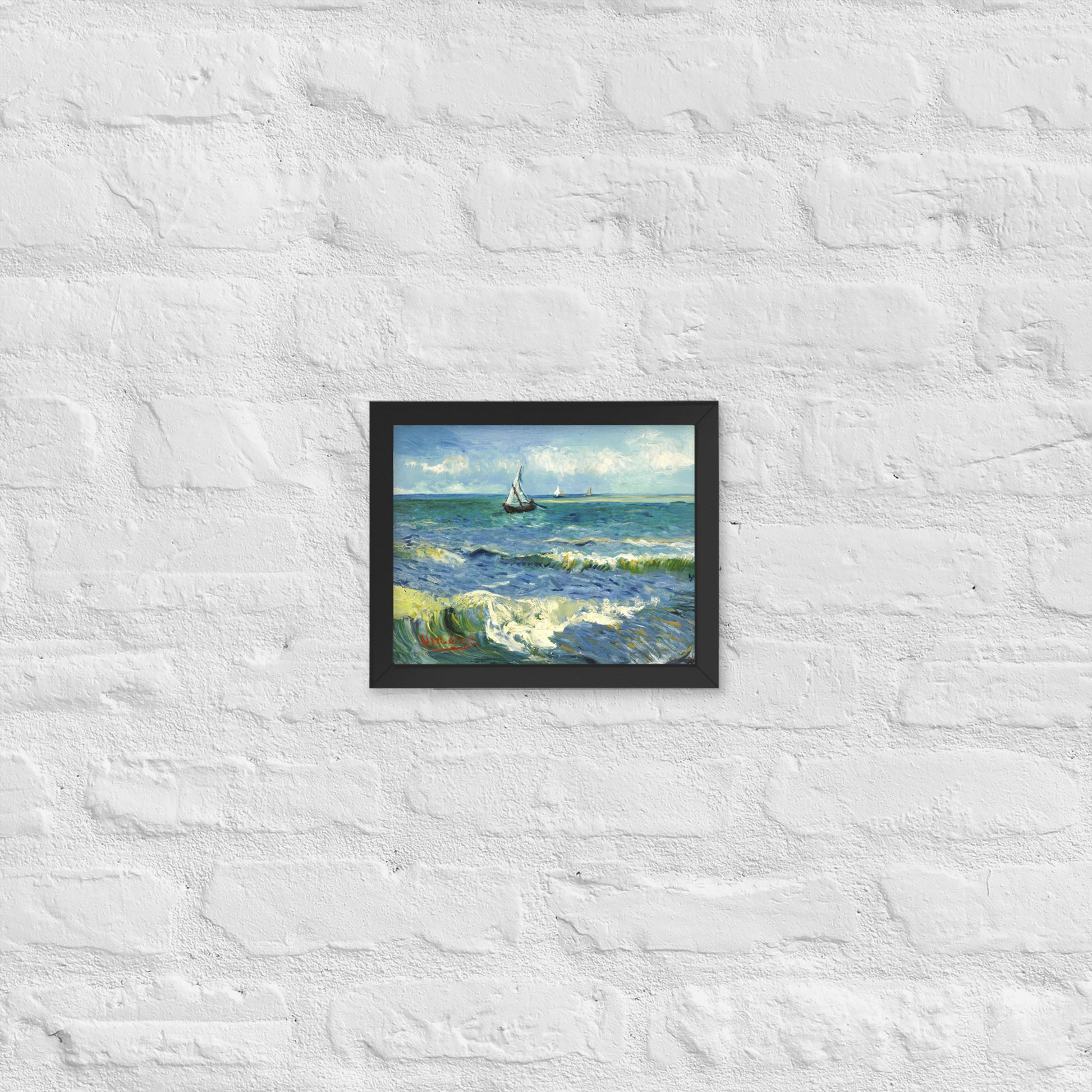 Van Gogh's 'The Sea at Les Saintes-Maries-de-la-Mer' on a 8"x10" black framed poster print on a white brick wall.