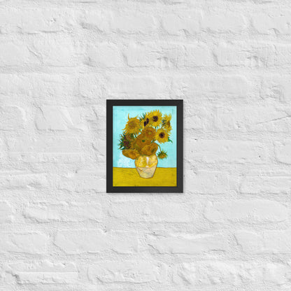 Van Gogh's 'Vase with Twelve Sunflowers' on a 8"x10" black framed poster print on a white brick wall.