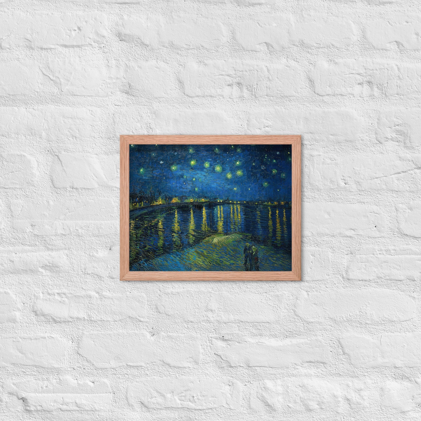 Van Gogh's 'Starry Night Over the Rhone' on a 11"x14" red oak framed poster print on a white brick wall.