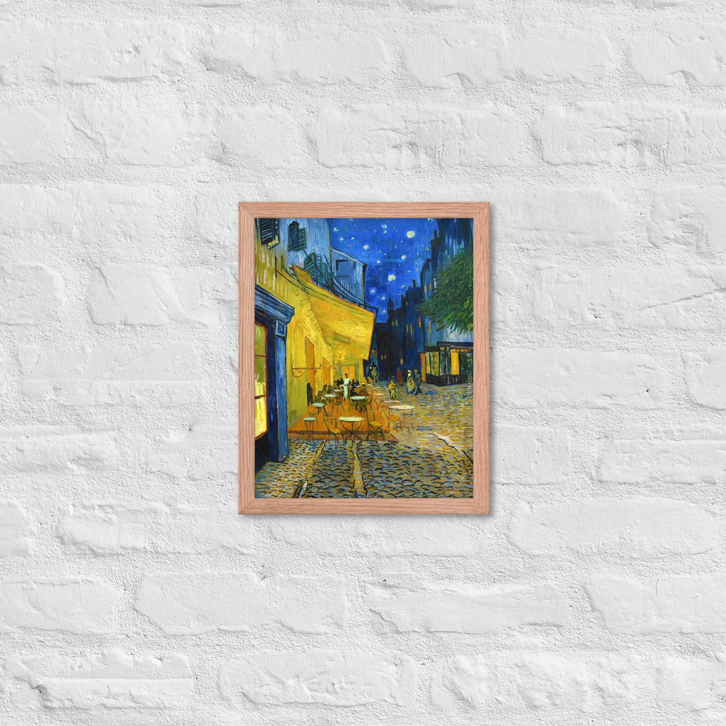 Van Gogh's 'Café Terrace at Night' on a 11"x14" red oak framed poster print on a white brick wall.