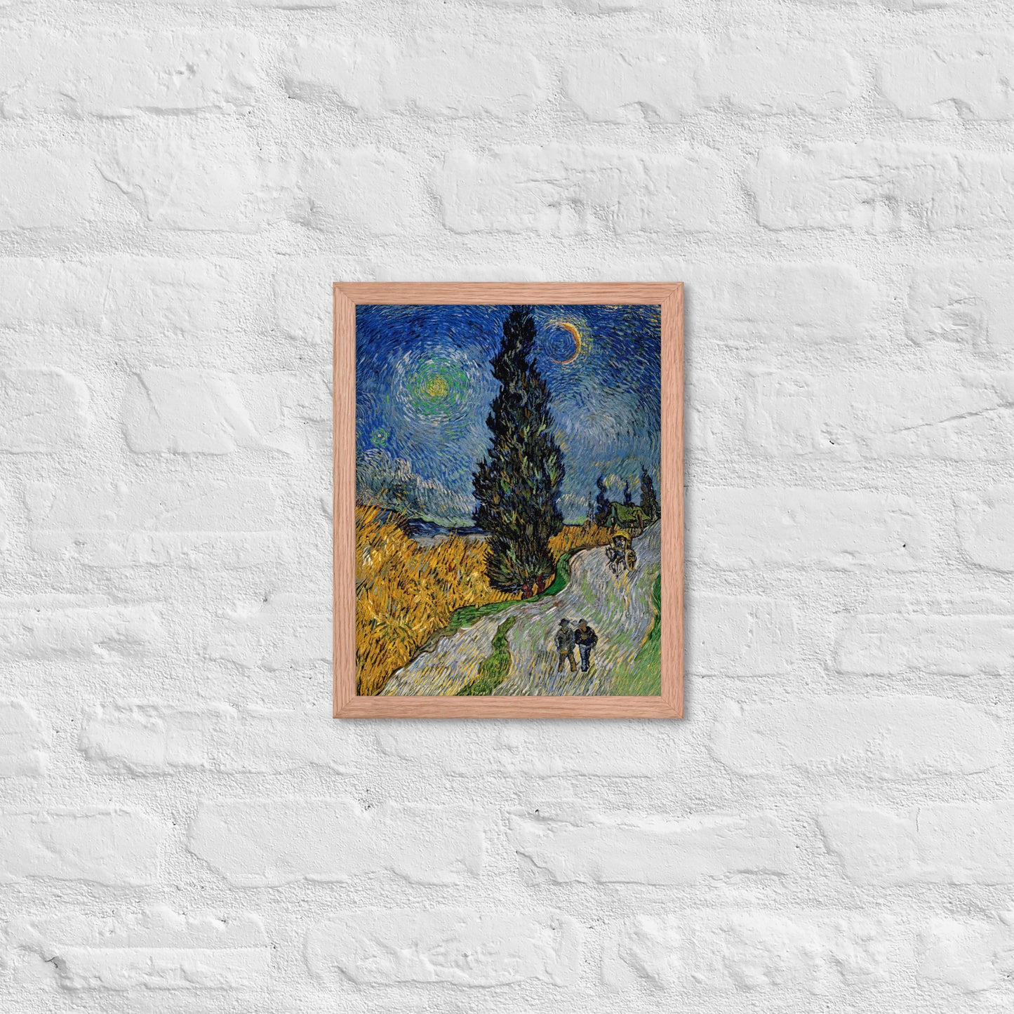 Van Gogh's 'Road with Cypress and Star' on a 11"x14" red oak framed poster print on a white brick wall.
