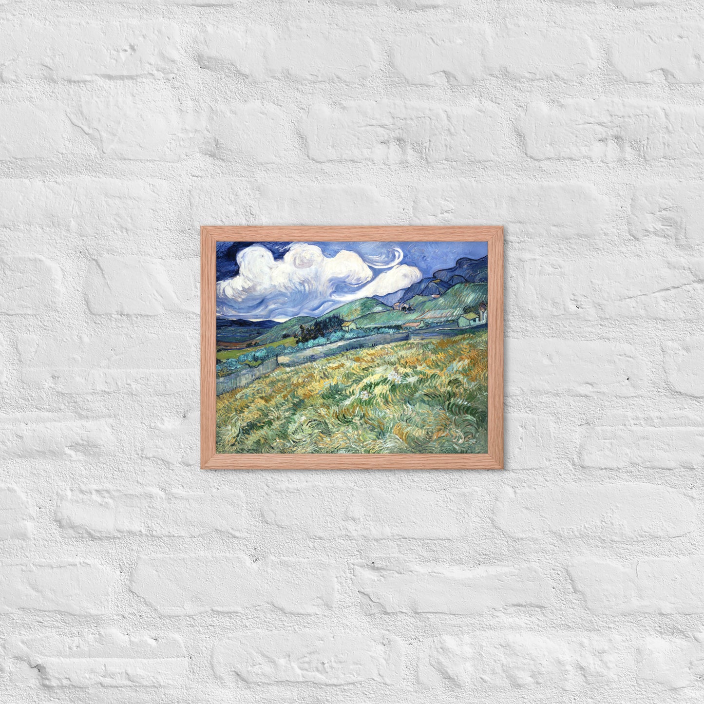 Van Gogh's 'Landscape from Saint-Rémy' on a 11"x14" red oak framed poster print on a white brick wall.