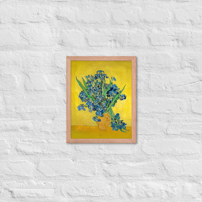 Van Gogh's 'Vase with Irises Against a Yellow Background' on a 11"x14" red oak framed poster print on a white brick wall.