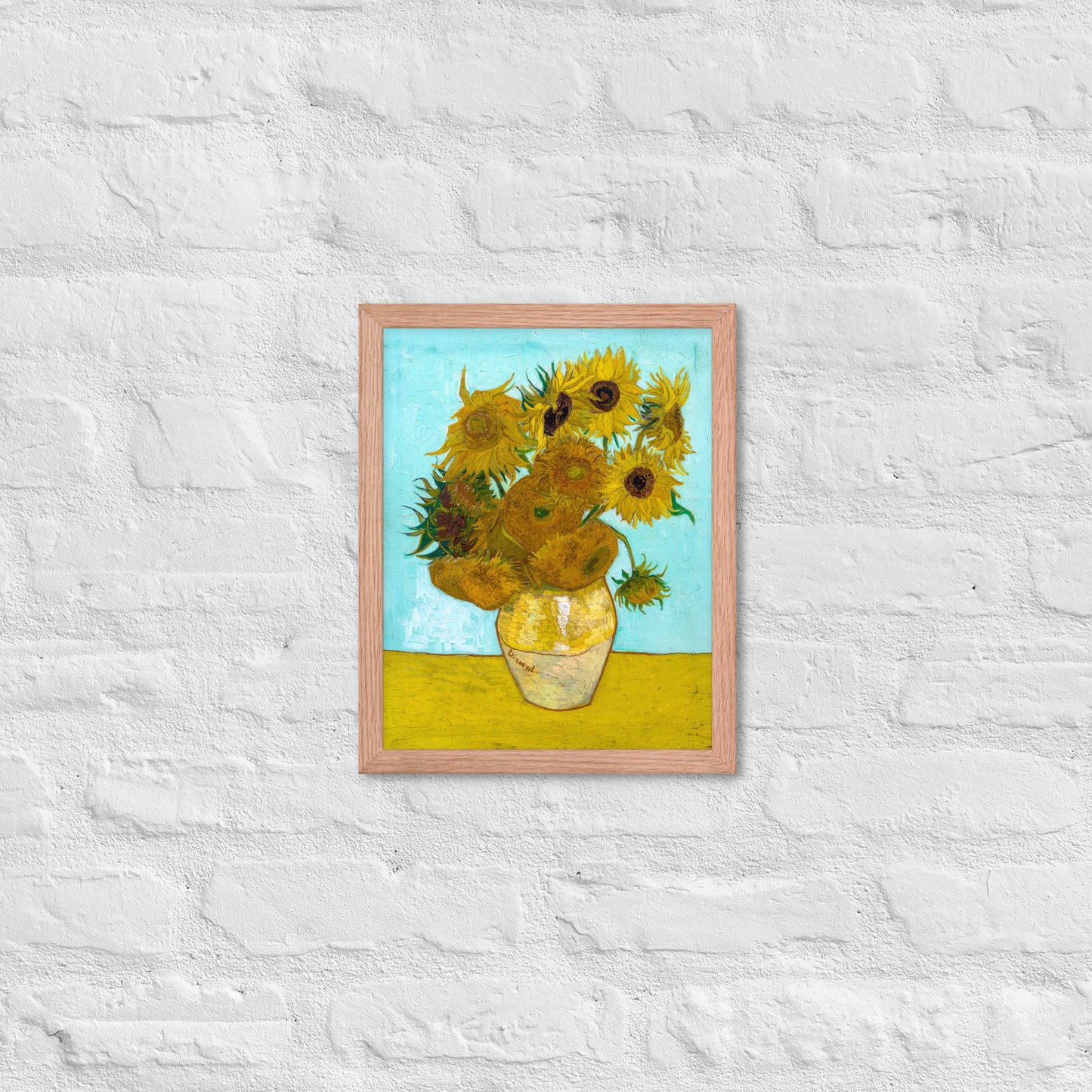 Van Gogh's 'Vase with Twelve Sunflowers' on a 11"x14" red oak framed poster print on a white brick wall.