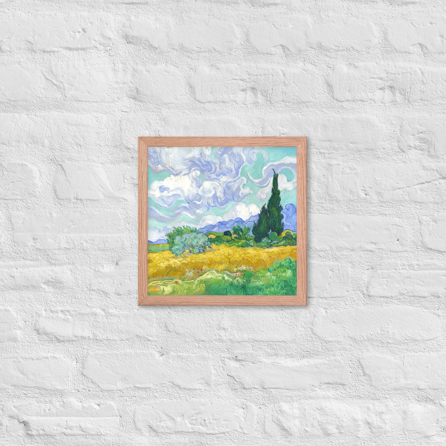 Van Gogh's 'Wheat Field with Cypresses' on a 12"x12" red oak framed poster print on a white brick wall.