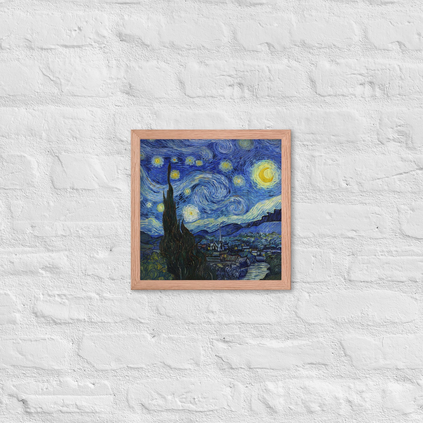 Van Gogh's 'Starry Night' on a 12"x12" red oak framed poster print on a white brick wall.