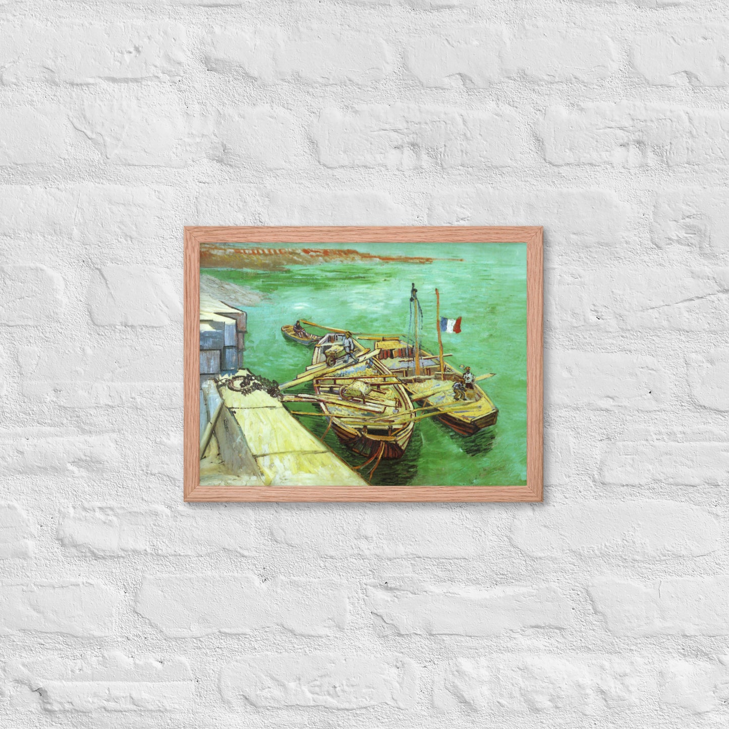 Van Gogh's 'Quay with Men Unloading Sand Barges' on a 12"x16" red oak framed poster print on a white brick wall.
