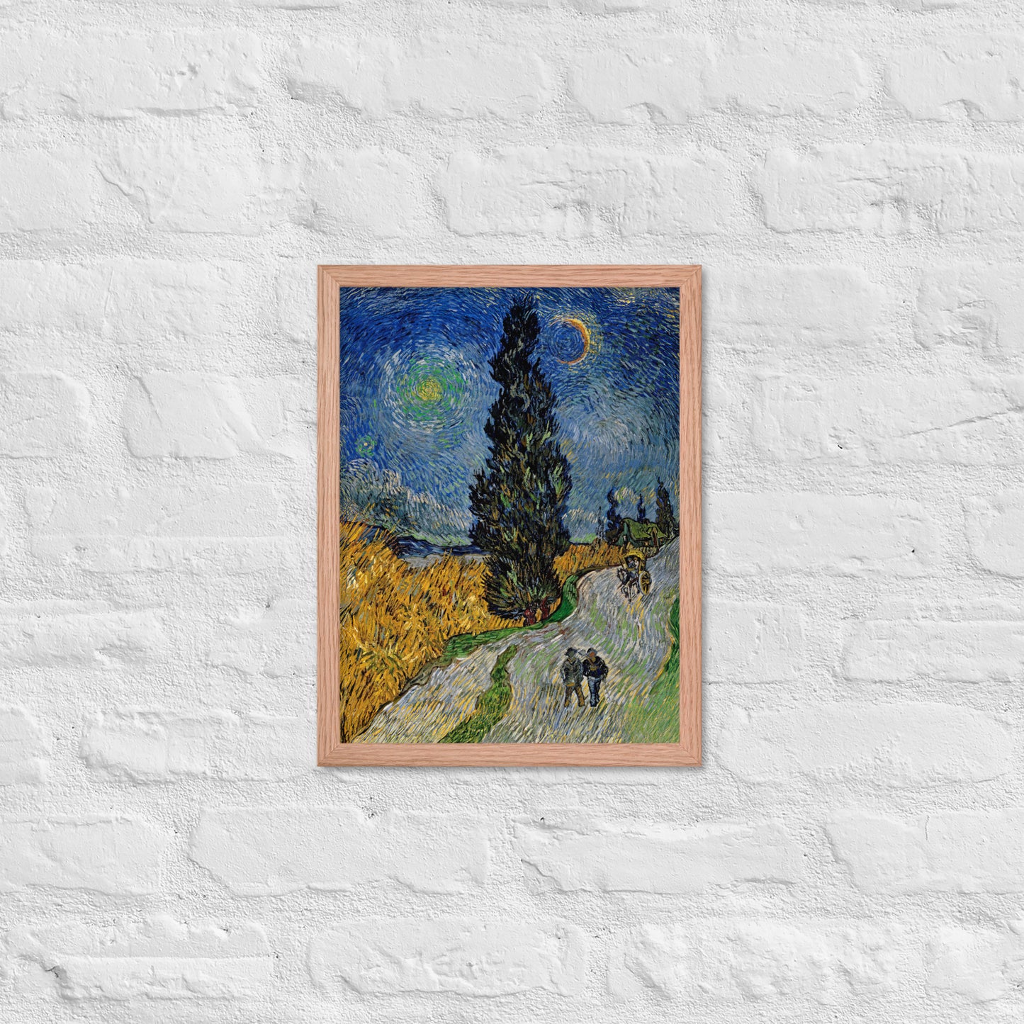 Van Gogh's 'Road with Cypress and Star' on a 12"x16" red oak framed poster print on a white brick wall.