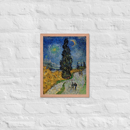 Van Gogh's 'Road with Cypress and Star' on a 12"x16" red oak framed poster print on a white brick wall.