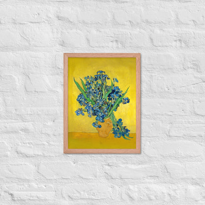 Van Gogh's 'Vase with Irises Against a Yellow Background' on a 12"x16" red oak framed poster print on a white brick wall.