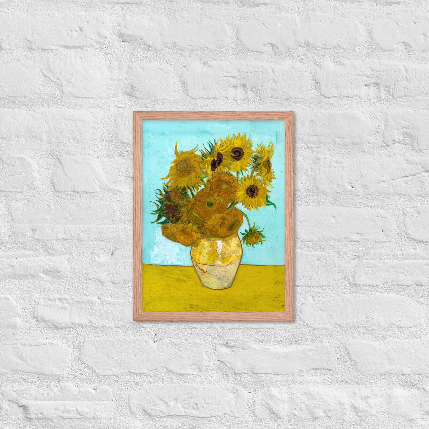 Van Gogh's 'Vase with Twelve Sunflowers' on a 12"x16" red oak framed poster print on a white brick wall.