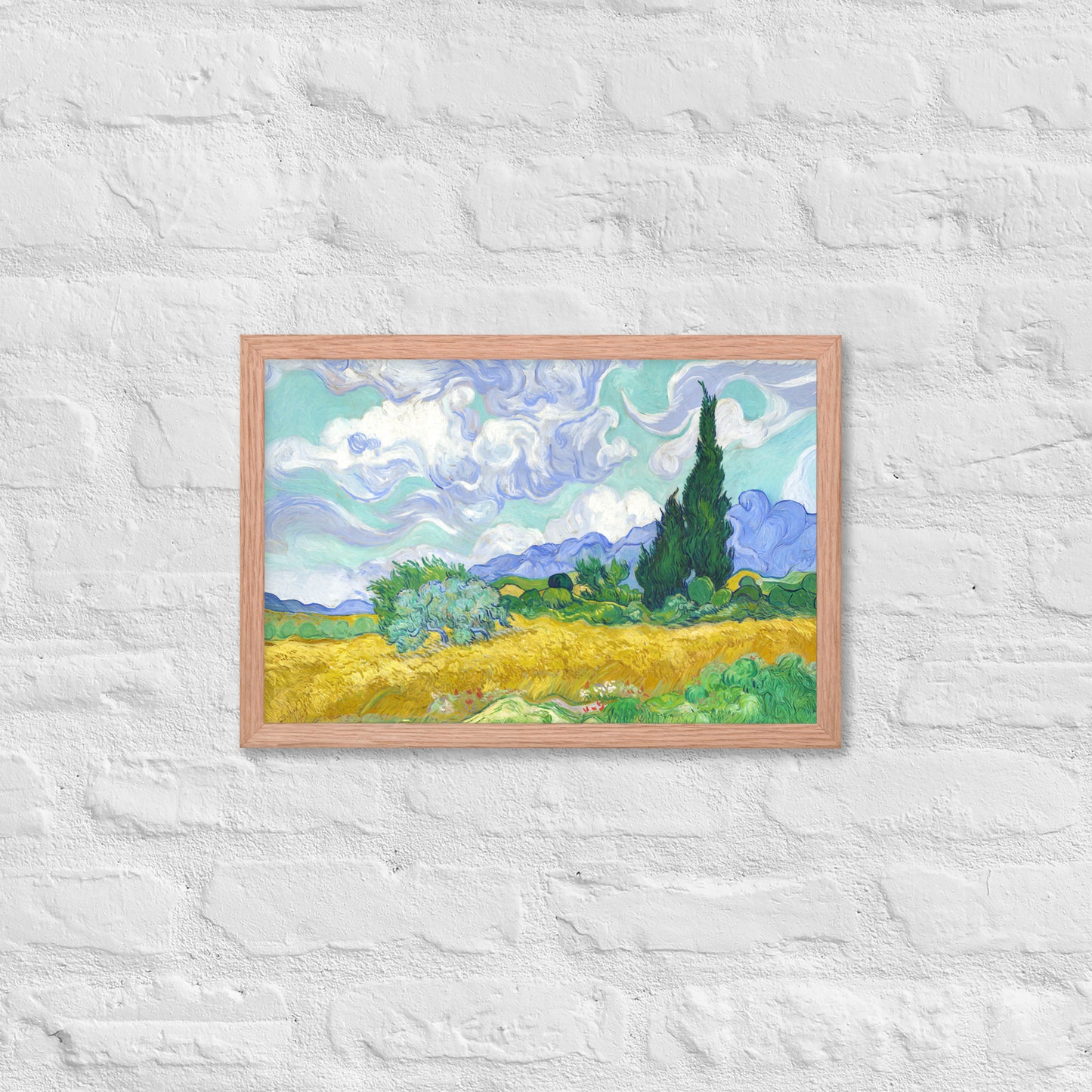 Van Gogh's 'Wheat Field with Cypresses' on a 12"x18" red oak framed poster print on a white brick wall.
