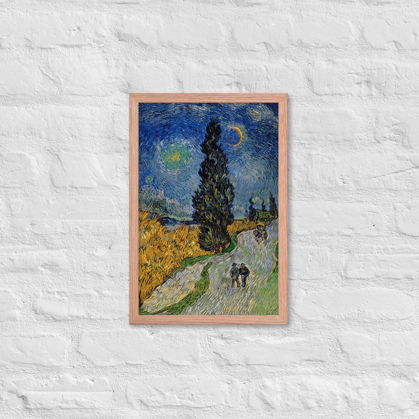 Van Gogh's 'Road with Cypress and Star' on a 12"x18" red oak framed poster print on a white brick wall.