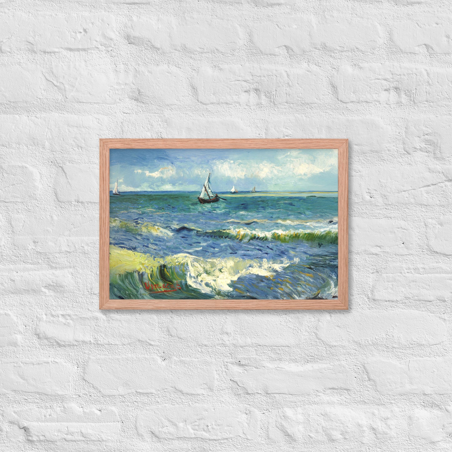 Van Gogh's 'The Sea at Les Saintes-Maries-de-la-Mer' on a 12"x18" red oak framed poster print on a white brick wall.