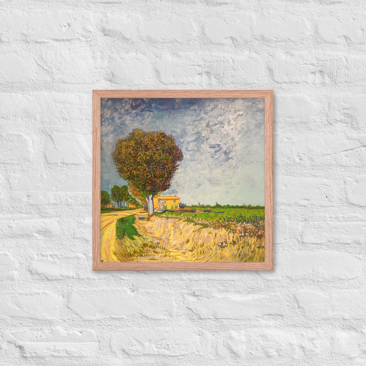 Van Gogh's 'A Lane near Arles' on a 16"x16" red oak framed poster print on a white brick wall.
